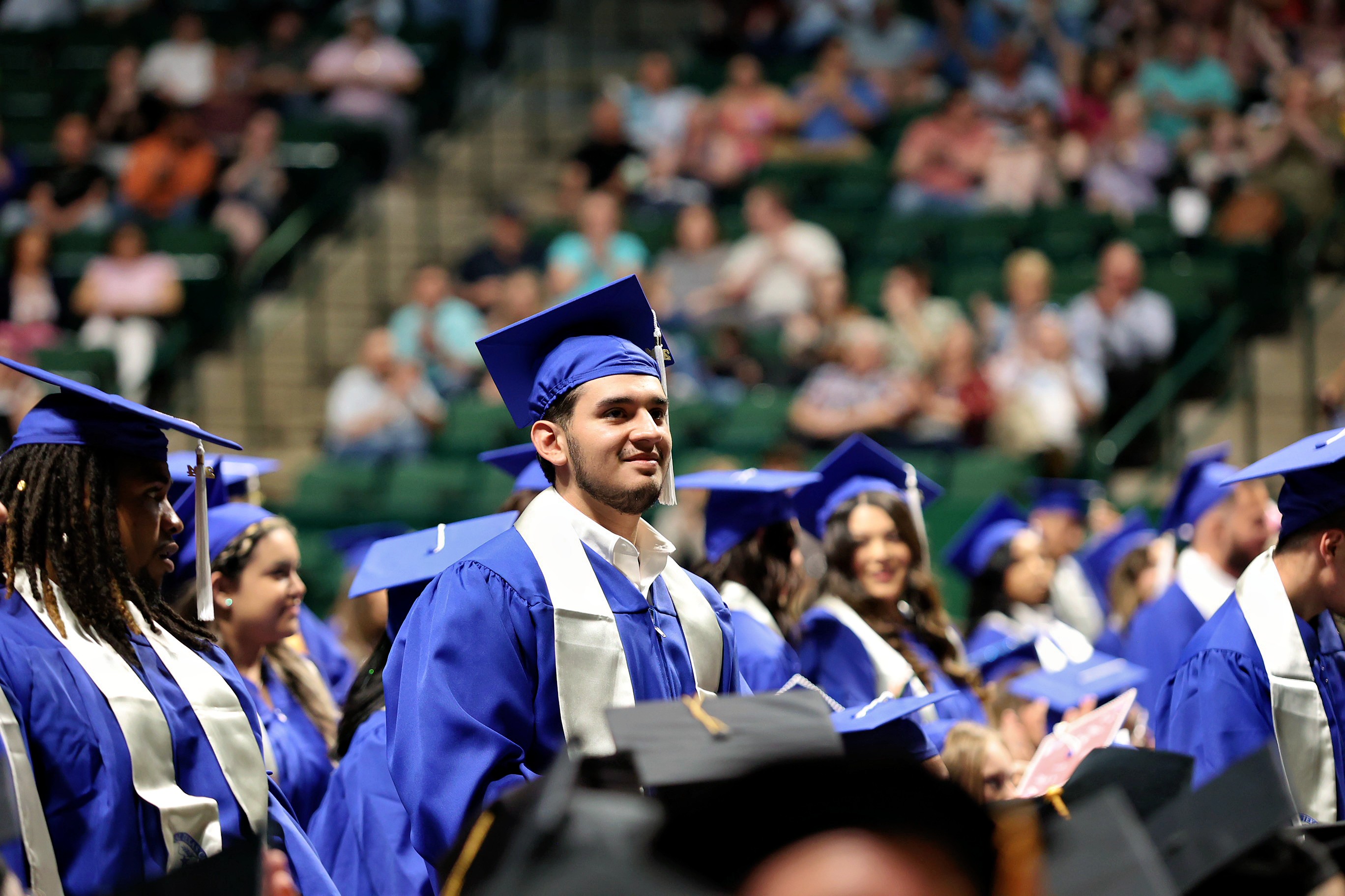 Graduate standing at ceremony in super pit